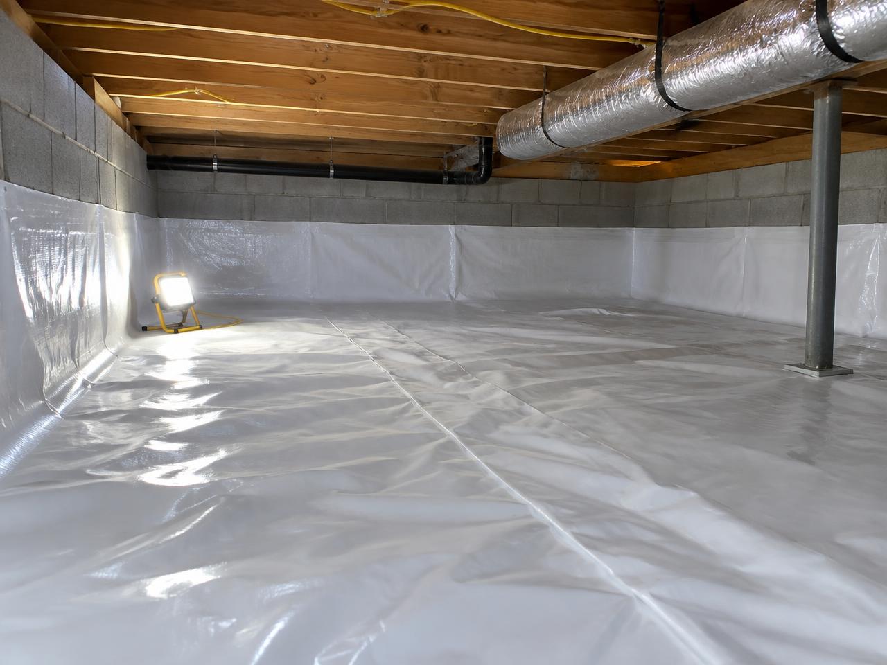 Heavy polyethylene vapor barrier covering a crawl space floor and walls in Northern Missouri